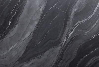 The image features a black and white marble pattern, which gives it a classic and elegant appearance. The primary subject is the marble pattern, which is the main focus of the image. The setting is a black and white marble surface, which serves as the backdrop for the pattern. The visual style is a close-up of the marble pattern, showcasing its intricate details. The colors and mood of the image are predominantly black and white, creating a timeless and sophisticated atmosphere.