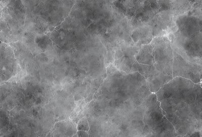 The primary subject of the image is a gray marble wall with a pattern of light and dark streaks. The setting is a room with a gray marble floor. The visual style is a close-up of the marble wall, showcasing its unique texture and pattern. The colors and mood of the image are predominantly gray, creating a calm and sophisticated atmosphere.