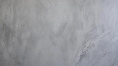 The primary subject of the image is a white marble wall with a textured surface. The setting is a room with a white marble wall as the main focus. The visual style is a drawing or illustration, with the artist's hand visible in the artwork. The colors and mood of the image are predominantly white, giving it a clean and minimalist appearance.