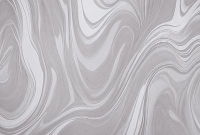The primary subject of the image is a large, gray, and white marble wall. The setting is a room with a white background, and the visual style is a close-up of the marble wall. The colors and mood of the image are predominantly gray and white, giving it a clean and elegant appearance.