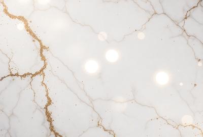 The primary subject of the image is a marble countertop with a gold-like pattern. The setting is a kitchen, and the visual style is a close-up of the marble countertop. The colors and mood of the image are predominantly white, with the gold-like pattern adding a touch of warmth and sophistication.