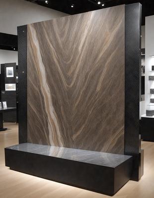 The primary subject of the image is a large stone wall, which is the main focus of the scene. The setting is a room with a black wall, and the visual style appears to be a photo. The colors and mood of the image are predominantly dark, with the stone wall being the main source of light and contrast.