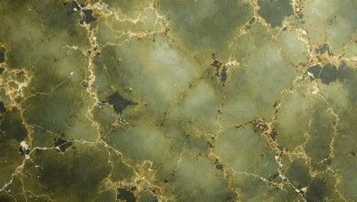 The primary subject of the image is a close-up of a green marble wall. The setting is a room with a green marble wall, which serves as the background. The visual style is a close-up of the marble wall, showcasing its texture and color. The dominant colors are green and brown, creating a natural and earthy atmosphere.