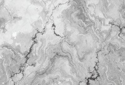 The image features a marble surface with a pattern of swirls and grooves. The primary subject is the marble, which is the main object, scene, or focus of the image. The setting is a marble countertop, and the visual style is a photo. The colors and mood of the image are predominantly gray, giving it a cool and sophisticated atmosphere.