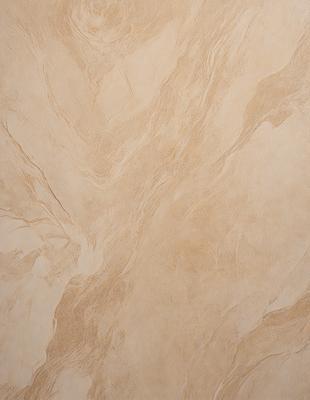 The primary subject of the image is a marble wall with a patterned texture. The setting is a room with a tan-colored wall, which adds to the warm and inviting atmosphere. The visual style is a close-up of the marble wall, showcasing its intricate pattern and texture. The colors and mood of the image are predominantly warm and earthy, with the marble wall serving as the focal point.