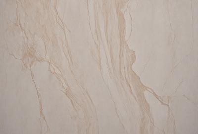 The primary subject of the image is a marble wall with a brown and white pattern. The setting is a room with a white background. The visual style is a close-up of the marble wall, showcasing its intricate design. The colors and mood of the image are warm and elegant, with the brown and white pattern adding a touch of sophistication to the overall atmosphere.