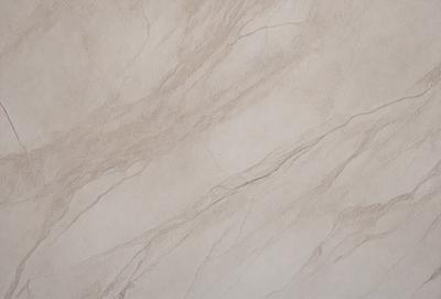 The primary subject of the image is a marble wall with a patterned texture. The setting is a room with a beige color scheme. The visual style is a close-up of the marble wall, showcasing its intricate design. The colors and mood of the image are warm and inviting, with the marble wall serving as a focal point in the room.