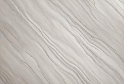 The primary subject of the image is a white marble wall with a pattern of waves. The setting is a room with a white marble floor. The visual style is a close-up of the marble wall, showcasing the intricate pattern of waves. The colors and mood of the image are predominantly white, giving it a clean and elegant appearance.