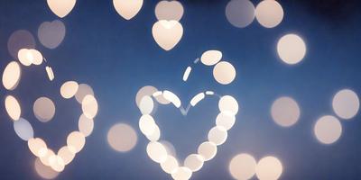 The primary subject of the image is a heart-shaped balloon, which is the main object, scene, or focus of the image. The setting is a blue sky, and the visual style is a photo. The heart-shaped balloon is the primary subject, and the overall atmosphere is light and cheerful.