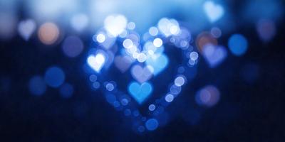 The primary subject of the image is a heart-shaped blue light, which is the main focus of the scene. The setting is a dark background, which contrasts with the bright blue light. The visual style of the image is a digital art or illustration, as it features a unique and artistic representation of a heart. The colors and mood of the image are predominantly blue, creating a calm and serene atmosphere.