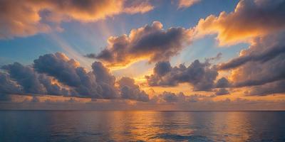 The primary subject of the image is a beautiful sunset over the ocean. The setting is a vast body of water with a cloudy sky above. The visual style of the image is a photo, capturing the stunning colors and atmosphere of the sunset. The dominant colors are orange, red, and yellow, creating a warm and serene mood.