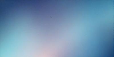 The primary subject of the image is a single star in the sky. The setting is a clear blue sky, with no clouds or other objects visible. The visual style is a photo, capturing the star and its surroundings. The colors and mood of the image are predominantly blue, creating a calm and serene atmosphere.