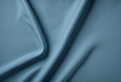 The primary subject of the image is a blue fabric, which is the main object, scene, or focus of the image. The setting or background is a blue cloth, and the visual style is a photo. The dominant colors and overall atmosphere are blue and calm.