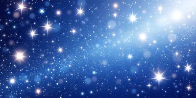 The primary subject of the image is a beautiful blue sky filled with stars. The setting is a nighttime sky, and the visual style is a photo. The colors and mood of the image are serene and peaceful, with the blue hue of the sky and the twinkling stars creating a sense of calmness and tranquility.