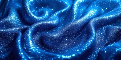 The primary subject of the image is a blue fabric with a shiny, glittery appearance. The setting is a dark background, which contrasts with the bright blue fabric. The visual style is a close-up of the fabric, showcasing its unique texture and appearance. The colors and mood of the image are predominantly blue, with a touch of glittery sparkles, creating a visually appealing and eye-catching scene.
