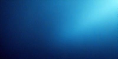 The primary subject of the image is a large, open body of water, which appears to be a deep blue ocean. The setting is a vast, empty space with no visible land or objects. The visual style of the image is a photo, capturing the beauty and tranquility of the ocean. The dominant colors are deep blue and black, creating a serene and peaceful atmosphere.