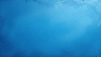 The primary subject of the image is a blue sky with clouds. The setting is a cloudy day, and the visual style is a painting or drawing. The colors and mood of the image are predominantly blue, creating a calm and serene atmosphere.