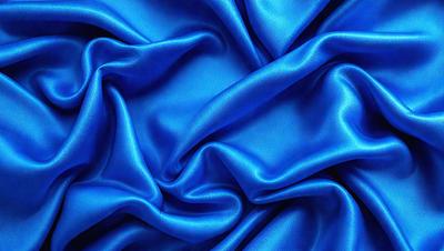 The primary subject of the image is a blue fabric, which is the main object, scene, or focus of the image. The setting or background is a blue cloth, and the visual style is a photo. The dominant colors and overall atmosphere are blue and serene.