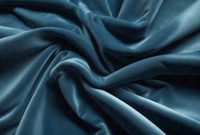 The primary subject of the image is a blue fabric, which is the main object, scene, or focus of the image. The setting/background consists of a blue cloth, and the visual style is a photo. The colors and mood of the image are predominantly blue, creating a calm and serene atmosphere.