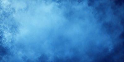 The primary subject of the image is a cloudy blue sky. The setting is a vast expanse of the sky, with no visible land or other objects. The visual style is a natural, outdoor scene. The colors and mood are predominantly blue, with a slightly overcast atmosphere.