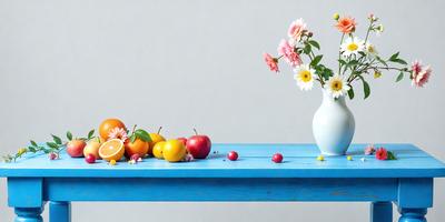 The primary subject of the image is a vase filled with flowers, placed on a blue table. The setting is a table with a blue surface, and the visual style is a photo. The colors in the image are predominantly blue and white, creating a calm and serene atmosphere.