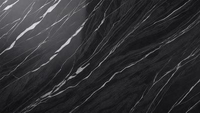 The primary subject of the image is a black and white marble pattern. The setting is a dark background, which contrasts with the marble pattern. The visual style is a close-up of the marble pattern, showcasing its intricate details. The colors and mood of the image are predominantly dark, with the marble pattern being the main focus and source of visual interest.