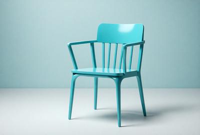 The primary subject of the image is a blue chair. The chair is placed on a white surface, which serves as the setting or background. The visual style of the image is a photo, capturing the chair in its natural environment. The dominant colors in the image are blue and white, creating a clean and modern atmosphere.