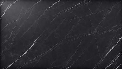 The primary subject of the image is a black marble countertop. The setting is a kitchen, with the countertop being the main focus of the scene. The visual style is a close-up of the marble countertop, showcasing its texture and appearance. The colors and mood of the image are predominantly dark, with the black marble countertop being the main source of contrast and visual interest.