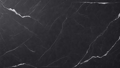 The primary subject of the image is a black marble countertop. The setting is a kitchen, with the countertop being the main focus of the scene. The visual style is a photo, capturing the natural texture and appearance of the marble countertop. The colors and mood of the image are predominantly dark, with the black marble providing a striking contrast against the surrounding environment.