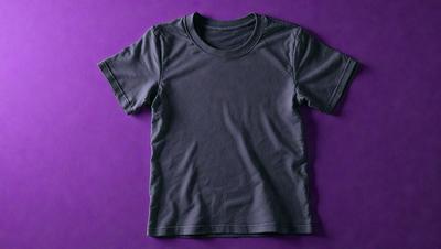 The primary subject of the image is a gray t-shirt. The setting is a purple background, which creates a contrasting color scheme. The visual style is a close-up of the t-shirt, showcasing its design and texture. The colors and mood of the image are predominantly gray and purple, giving it a calm and subdued atmosphere.