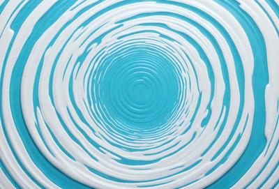 The primary subject of the image is a blue spiral, which appears to be a swirl or a vortex. The setting is a blue background, and the visual style is a close-up of the spiral. The colors and mood of the image are predominantly blue, creating a calm and serene atmosphere.