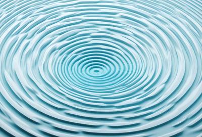 The primary subject of the image is a blue, swirling, circular water pattern. The setting is a blue surface, possibly a pool of water or a blue background. The visual style appears to be a digital art or illustration, as the swirling pattern is created with precision. The dominant colors are blue, and the overall atmosphere is calm and serene.