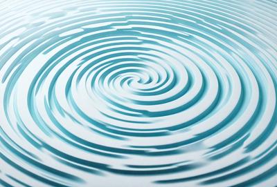 The primary subject of the image is a swirling, blue water pattern. The setting is a white surface, possibly a wall or a table, where the water pattern is displayed. The visual style appears to be a digital art or illustration, as the swirling pattern is created with precision and detail. The dominant colors are blue and white, giving the image a calming and serene atmosphere.