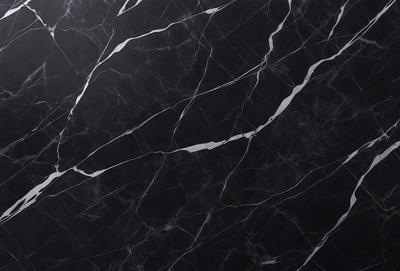 The primary subject of the image is a black and white marble countertop. The setting is a kitchen, with the countertop being the main focus of the scene. The visual style is a close-up of the marble countertop, showcasing its texture and pattern. The colors and mood of the image are predominantly black and white, giving it a classic and elegant appearance.