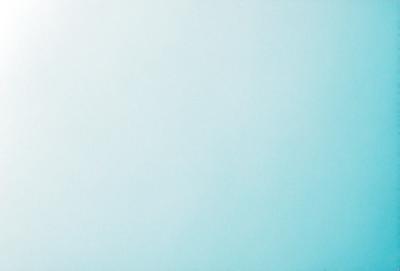 The primary subject of the image is a large, empty, and blue wall. The setting is a room with a white background. The visual style is a photo, and the colors and mood are predominantly blue, creating a calm and serene atmosphere.