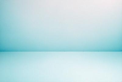 The primary subject of the image is a white wall with a blue background. The setting is a room with a blue surface, and the visual style is a photo. The colors and mood of the image are predominantly blue, creating a calm and serene atmosphere.