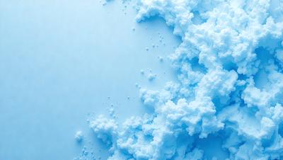 The primary subject of the image is a close-up of a white surface with blue frosting or icing. The setting appears to be a kitchen or a similar environment where food is prepared. The visual style of the image is a close-up of the frosting, which gives it a textured and detailed appearance. The dominant colors in the image are white and blue, creating a clean and fresh atmosphere.