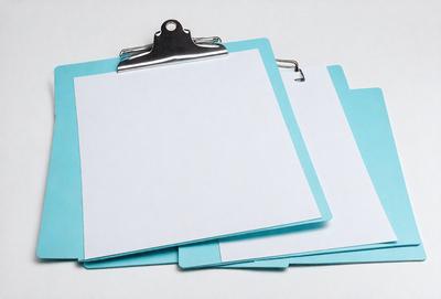 The primary subject of the image is a blue folder with a white piece of paper inside. The folder is open and placed on a white surface. The visual style of the image is a photo, and the colors and mood are predominantly blue and white.