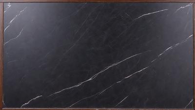 The primary subject of the image is a black marble countertop. The setting is a kitchen, with the countertop being the main focus of the scene. The visual style is a close-up of the marble countertop, showcasing its texture and appearance. The colors and mood of the image are predominantly dark, with the black marble countertop being the main source of contrast and visual interest.
