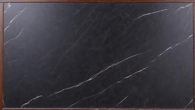 The primary subject of the image is a black marble countertop. The setting is a kitchen, with the countertop being the main focus of the scene. The visual style is a close-up of the marble countertop, showcasing its texture and appearance. The colors and mood of the image are predominantly dark, with the black marble countertop being the most prominent element.