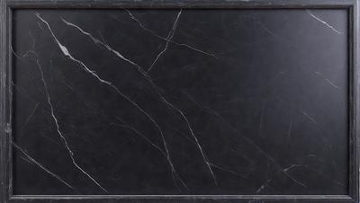 The primary subject of the image is a black marble countertop. The setting is a kitchen, with the countertop being the main focus of the scene. The visual style is a close-up of the marble countertop, showcasing its texture and details. The colors and mood of the image are dark and moody, with the black marble countertop being the dominant color.