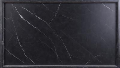 The primary subject of the image is a black marble countertop. The setting is a kitchen, with the countertop being the main focus of the scene. The visual style is a close-up of the marble countertop, showcasing its texture and details. The colors and mood of the image are dark and moody, with the black marble countertop being the dominant color.