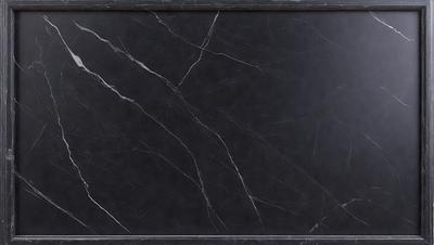 The primary subject of the image is a black marble countertop. The setting is a kitchen, with the countertop being the main focus of the scene. The visual style is a close-up of the marble countertop, showcasing its texture and details. The colors and mood of the image are dark and moody, with the black marble countertop being the dominant color.