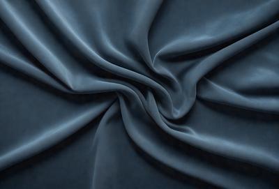 The primary subject of the image is a blue fabric, which is the main object, scene, or focus of the image. The setting or background is a blue cloth, and the visual style is a photo. The colors and mood of the image are predominantly blue, creating a calm and serene atmosphere.