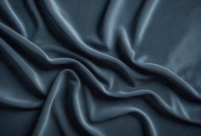 The primary subject of the image is a blue fabric, which appears to be a piece of cloth or a curtain. The setting is a dark room, and the visual style is a close-up of the fabric. The colors and mood of the image are predominantly dark and moody, with the blue fabric being the main focus.
