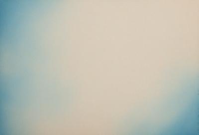 The primary subject of the image is a large, empty, and white space. The setting is a cloudy sky, and the visual style is a photo. The colors and mood of the image are predominantly gray and calm, with a hint of tranquility.