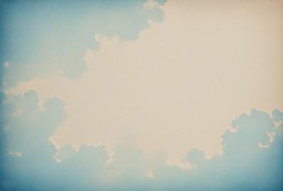 The primary subject of the image is a cloudy blue sky. The setting is a vast, open space with no visible landmarks or objects. The visual style is a painting or drawing, with a focus on the cloudy sky and its various shapes and patterns. The colors and mood of the image are predominantly blue and serene, creating a sense of tranquility and openness.