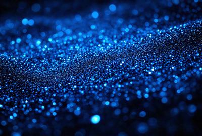 The primary subject of the image is a blue background with a pattern of blue and white sparkles. The setting appears to be a dark room, and the visual style is a close-up of the blue background with the sparkles. The colors and mood of the image are predominantly dark and moody, with the blue sparkles adding a touch of brightness and interest to the scene.
