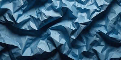 The primary subject of the image is a blue paper, which is the main object, scene, or focus of the image. The setting or background is a blue surface, which could be a wall or a piece of fabric. The visual style of the image is a close-up of the blue paper, showcasing its texture and details. The colors and mood of the image are predominantly blue, creating a calm and serene atmosphere.
