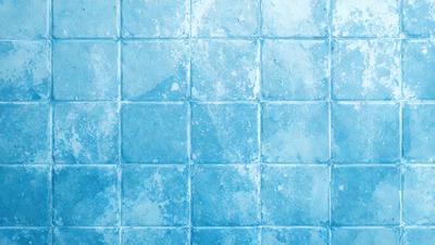 The primary subject of the image is a blue tile wall. The setting is a bathroom, as indicated by the blue tiles. The visual style is a close-up of the tiles, showcasing their texture and design. The dominant colors are blue and white, creating a calm and soothing atmosphere.